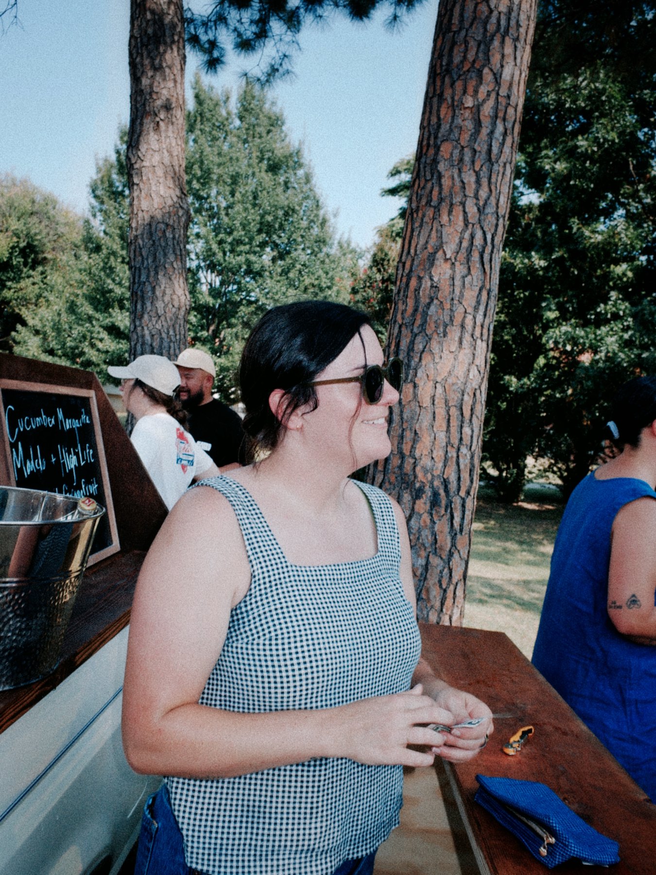 Guest smiling near the chalkboard drink menu